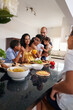 © Caia Image - Family preparing food in kitchen