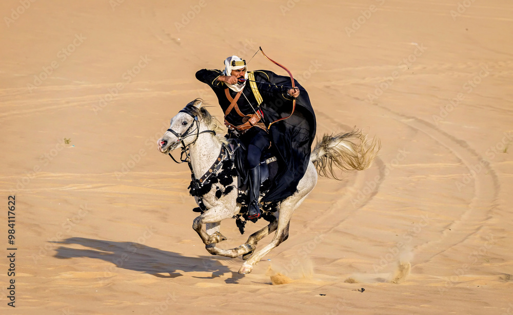 Arabian Archer riding full speed on his horse in the empty quarter ...