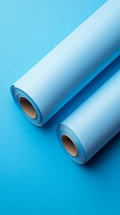 Wall Mural - Two Rolls of Pastel Blue Paper on a Light Blue Background