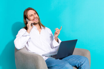 Poster - Photo of handsome good mood guy wear white shirt talking modern gadget pointing emtpy space isolated blue color background