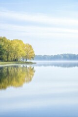 Poster - Tranquil Lake Scene with a Serene Boat Gently Floating on the Water, Surrounded by Lush Natural Landscapes and Reflective Surface Under a Clear Blue Sky