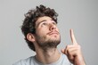 © Oleksandr - Man Looking Up Isolated. Young handsome Caucasian man pointing up with finger over solid background