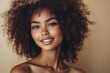 © Vooglo - A confident woman with voluminous curls, her face lifted in a graceful pose with a soft smile