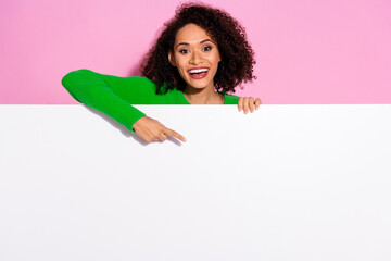 Poster - Photo portrait of lovely young lady point down white empty space dressed stylish green garment isolated on pink color background