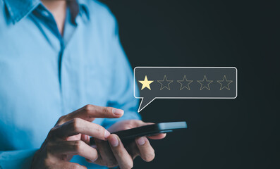 negative customer review concept. a person use smartphone to give a one-star rating, symbolizing cus