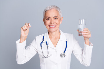 Canvas Print - Photo of attractive confident woman specialist wear white robe hold fresh clear water pills isolated on grey color background