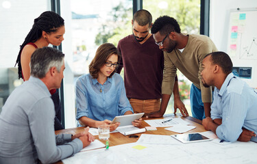 Canvas Print - Group, architect and reading of tablet, blueprint and teamwork for floor plan, serious and office. Digital, documents and people in boardroom, designer and collaboration of colleagues and project