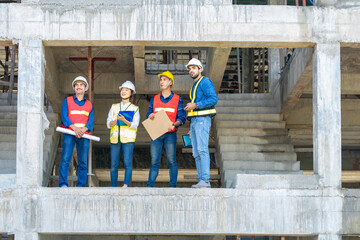 construction workers in full safety gear while work on height and dangerous, engineering teamwork inspecting in the building under construction site