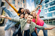 © Davide Angelini - Multi ethnic young people smiling together at camera outdoors - Happy group of friends having fun hanging out in downtown street - University students standing together in college campus