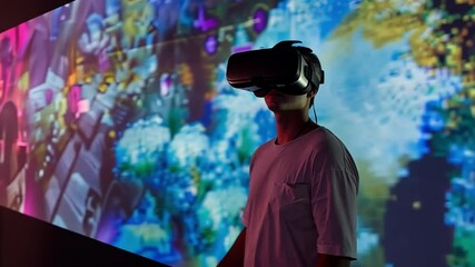 Poster - A participant wearing a virtual reality headset engages with vibrant digital art displayed on large screens in a contemporary art exhibit. The atmosphere is lively and dynamic.