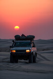 Off-road vehicle at sunset in desert landscape. Generative AI image