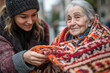 © Alexandra - Young smiling volunteer is helping an elderly woman by covering her with a blanket
