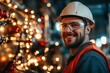 © Larisa - Smiling worker in hard hat with festive lights backdrop.