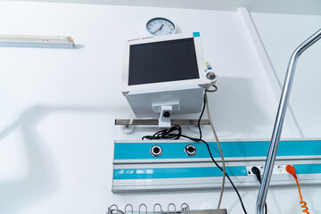 Wall Mural - A hospital room with a clock on the wall and a monitor on the wall. The monitor is black and white