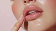 © netrun78 - Close-up of soft pink lips with glossy finish, highlighting natural beauty and smooth application of lip gloss on a serene white background