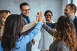 © Dragana Gordic - Team Celebrating Success with Group High Five in Office