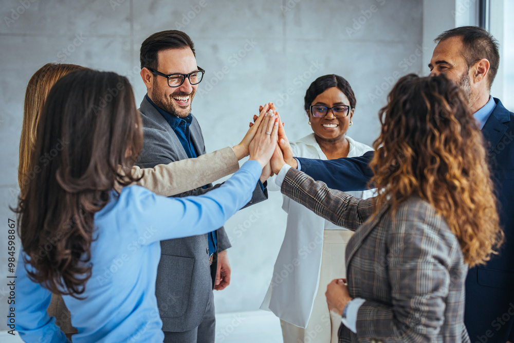 Diverse Team Celebrating Success With High Five in Office Stock Photo ...