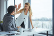 © Dragana Gordic - Colleagues Celebrating Success With a High-Five in Modern Office