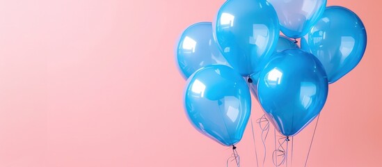 Aerial shot of blue balloons against a soft pink backdrop, ideal for celebratory greetings with clear copy space.