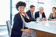 © peopleimages.com - Woman, boardroom and happy in meeting on portrait in confidence for planning and brainstorming. Female person, employee and smile with pride at office for teamwork or collaboration on strategy