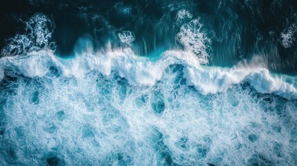 Wall Mural - Aerial view of dynamic ocean waves crashing against the shore, showcasing nature's beauty.