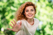 © deagreez - Portrait of pretty young woman raise arm invite you wear t-shirt pastime walk fresh air park outdoors