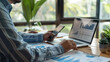 © Santy Hong - A self-employed consultant discussing Social Security options with an accountant via video call, with a financial report and laptop open on the desk