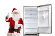 © Ljupco Smokovski - Santa claus leaning on an empty open fridge and showing thumbs up