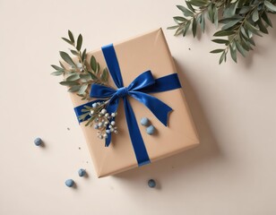 A gift box wrapped in beige paper with a blue rib. Shell and fir branch