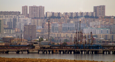 City on the background of two chemical chimneys . High quality photo