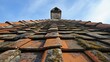 © Charoen - Roofing in historic preservation, with experts carefully restoring the roof of a centuries-old building using traditional methods