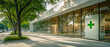 © Pics_With_Love - Modern Pharmacy Building with Glass Front and Green Cross Symbol on a Quiet Street