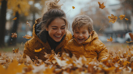 Canvas Print - A woman and her son laugh together in a pile of autumn leaves.