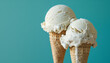 © wolfelarry - Two scoops of Vanilla ice cream on top ice cream cone blue background