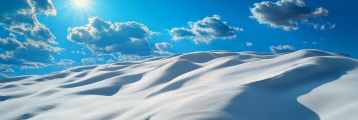 Expansive white sand dunes stretch across the horizon under a vibrant blue sky, dotted with fluffy white clouds.  The scene evokes a sense of serenity, vastness, and the beauty of nature.