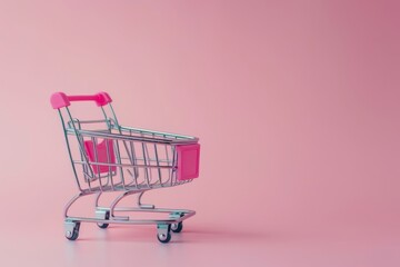 Empty shopping cart on pink background with copy space