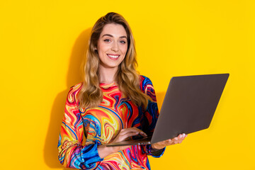 Canvas Print - Photo portrait of attractive young woman hold netbook dressed stylish colorful clothes isolated on yellow color background