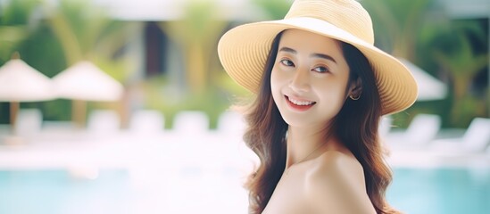 Canvas Print - Smiling Woman in a Straw Hat at a Pool