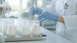 © forenna - laboratory scene featuring multiple samples of alternative milk products on a workstation, with a food scientist conducting tests, highlighting the growing trend and research in al