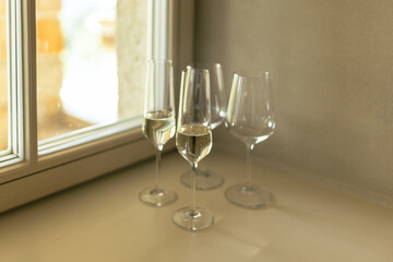 Crystal glass of sparkling wine served on windowsill. New year or wedding party