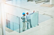 © ThurstanJam/peopleimages.com - Architecture, construction and business men with discussion and tablet blueprint, building planning for talk. Above engineers, property development or contractors on stairs pointing for floor plan