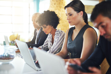People, tech and connectivity in office for business, lead generation and networking for company growth. Men, women and laptop at shared desk for communication, feedback and workforce for development