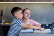 © volody10 - Mother helping her son doing homework in kitchen