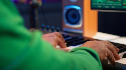 Leinwandbilder - Sound engineer playing piano and mixing tunes on digital software, composing new songs and adding audio effects in post production. Artist composer creating soundtracks for music industry. Camera A.