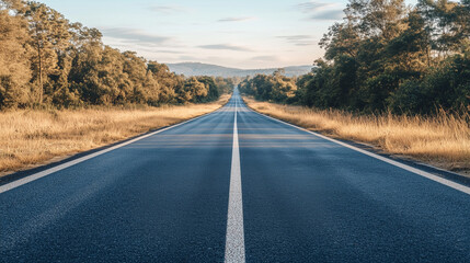 Low level view of empty old paved road in mountain area at sunset