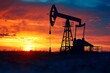© atar - Silhouette of oil pumpjack at sunset with red and orange sky