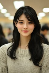 Wall Mural - Portrait of a Young Woman with Long Black Hair and a Knit Sweater