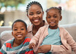 © Nina2024/peopleimages.com - Portrait, happy black family and mother with kids on sofa at home for love, care or people relax. Smile, face or African children with mom for hug, trust or support with single parent or babysitter