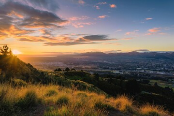 Panoramic image of Christchurch, New Zealand at sunrise. Majestic mountain range in background, peak rising high. Beautiful cityscape with modern architecture. Stunning landscape with nature colors.