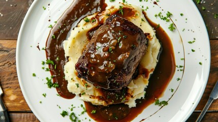 Roast Beef with Demi Glace Gravy and Mashed Potatoes: A Top View on a White Plate